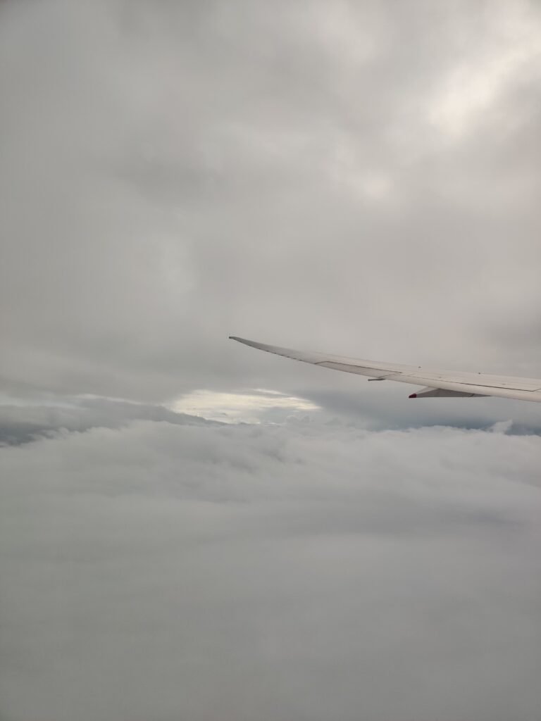 Singapore airline flight hovering over the cloud to bali, indonesia