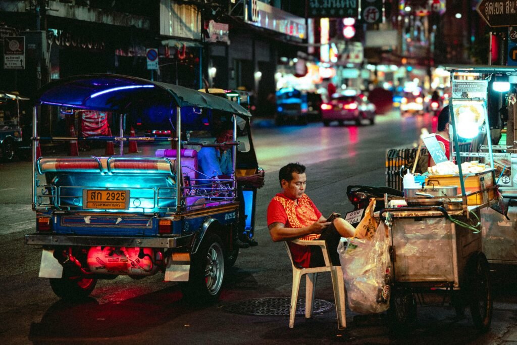 First time travel to thailand Colorful night scene of a street vendor and tuk-tuk in bustling Thailand.